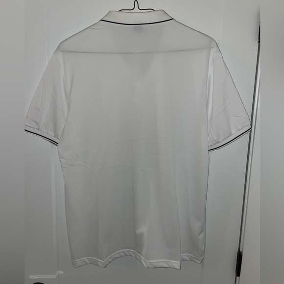 White polo with black trim around the collar and sleeves. 100% polyester. - Picture 3 of 3